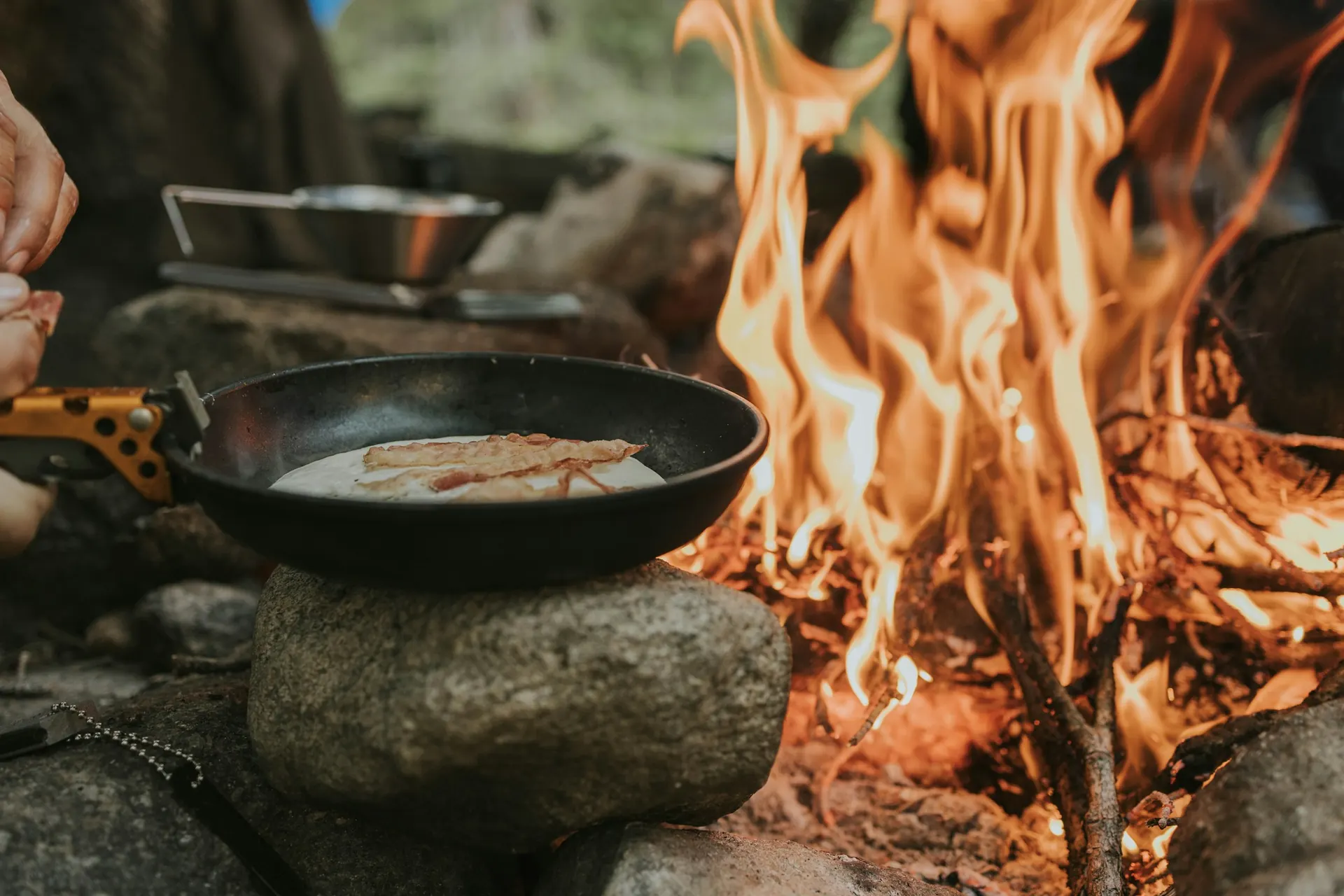 A cast-iron skillet over a campfire