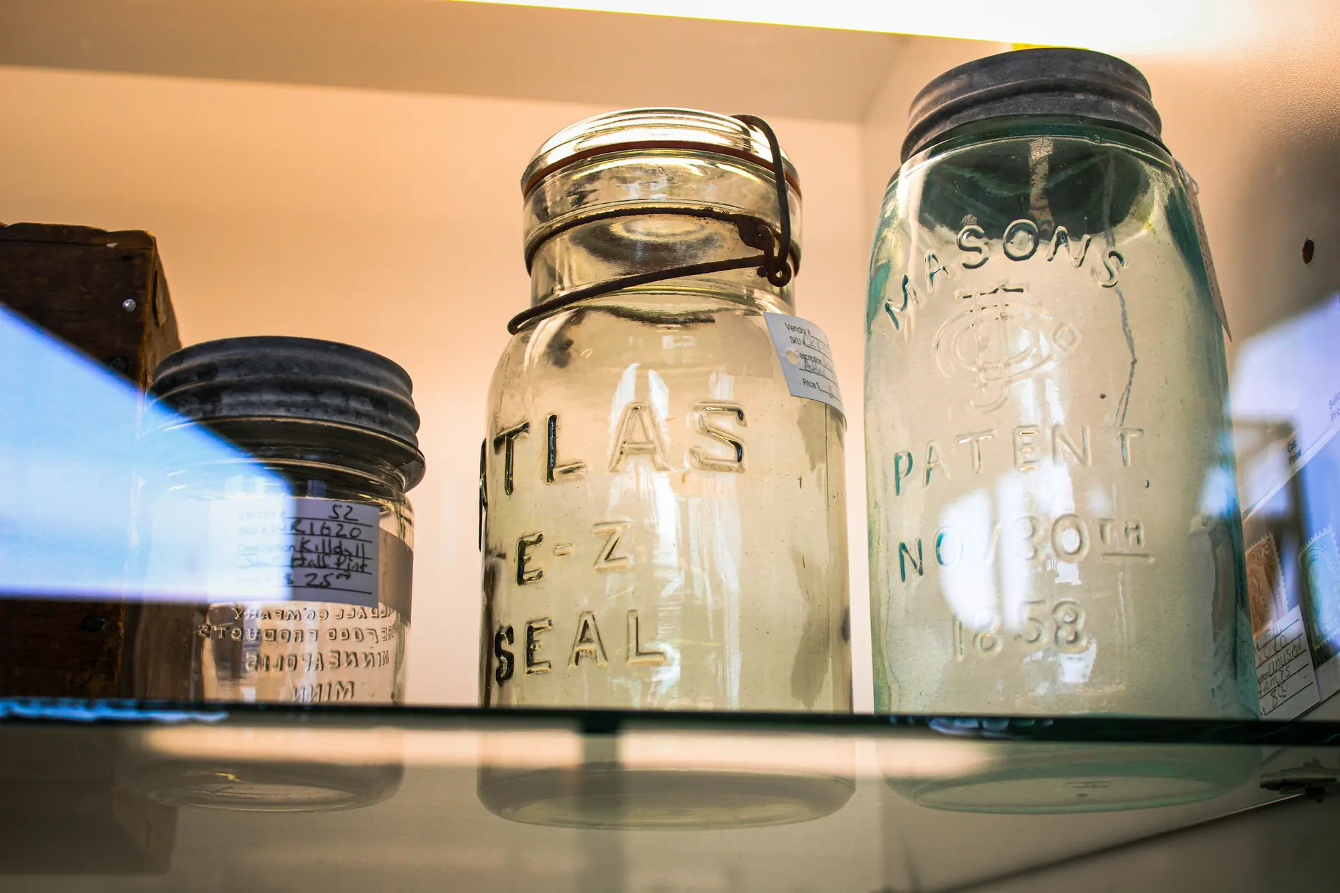 Vintage glass canning jars on a shelf